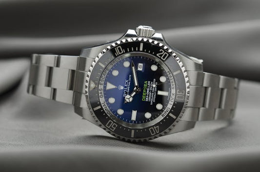 Close-up of a luxury Rolex watch with a sleek stainless steel bracelet, representing high-end timepieces like Rolex and Patek Philippe. A guide to luxury watch investments and their value over time.
